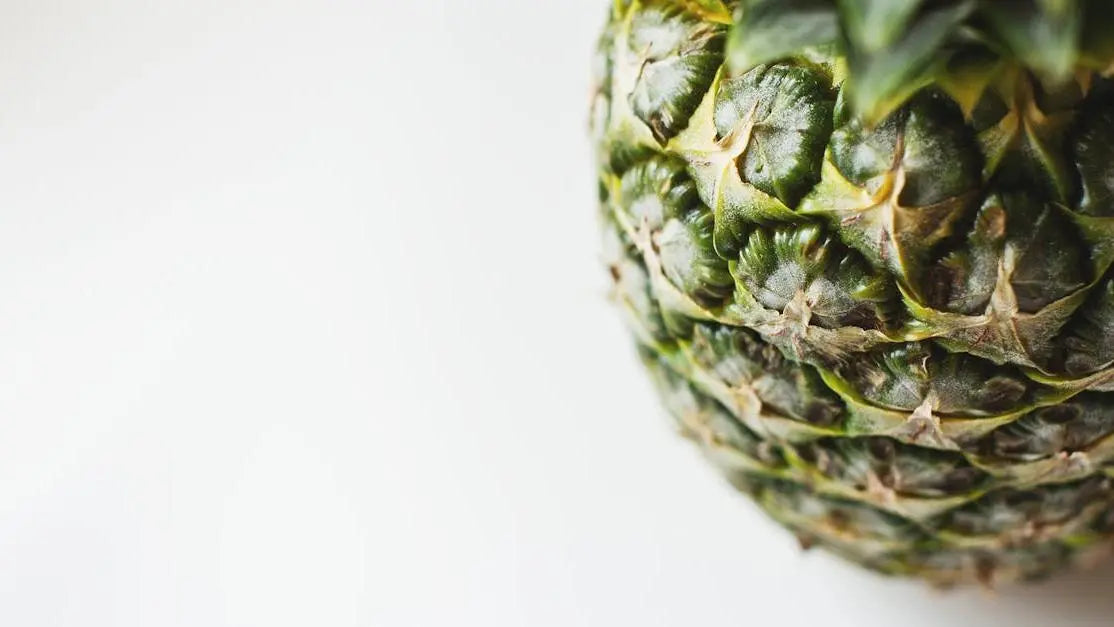 Close-up fresh pineapple symbolizing bromelain skin benefits on a clean white background