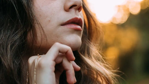 Golden hour close-up of serene woman in Dourados, Brazil, showcasing celebrity skincare secrets